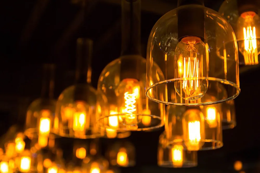 Man standing in an office looking out of the window 